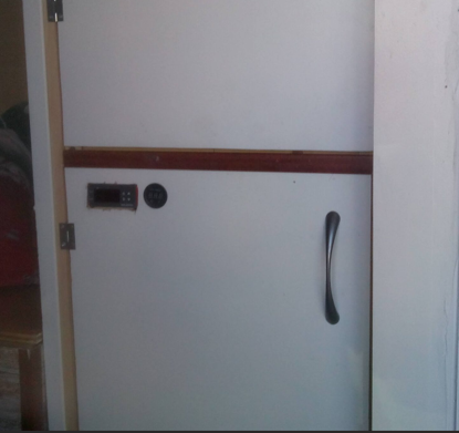 12V control panel for a coolant water heating system on a camper van cabinet door